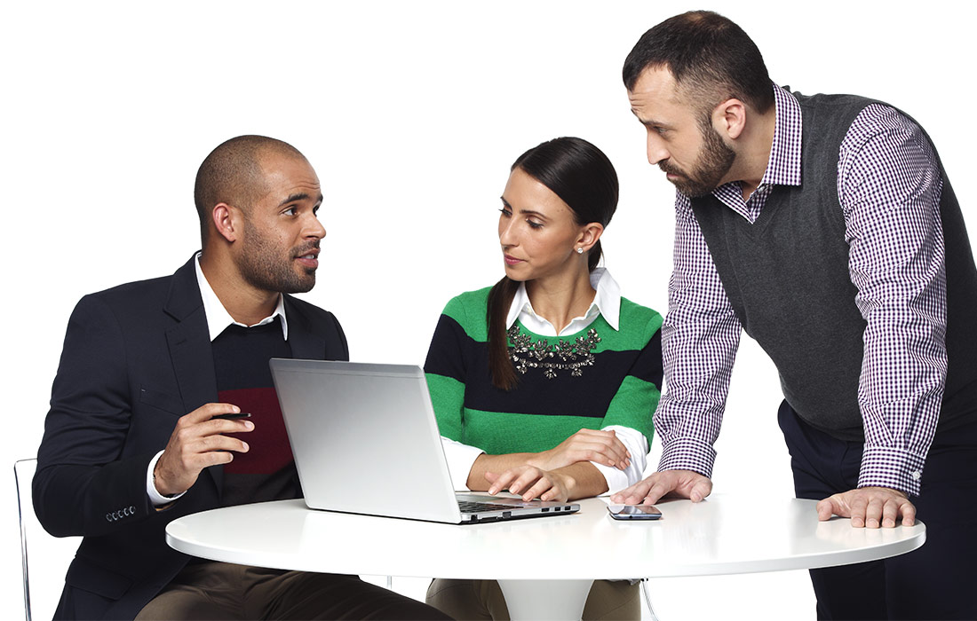 Co-workers in front of a laptop